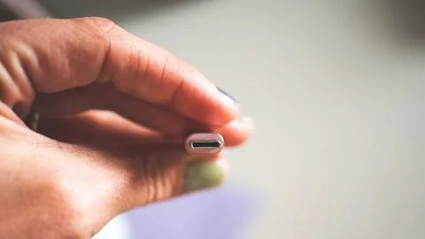 A hand holding usb plug c type close up minimalist technology Foto stock