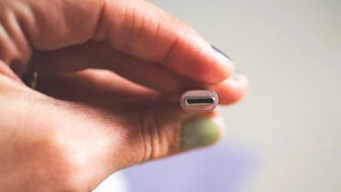 A hand holding usb plug c type close up minimalist technology Stock Photos