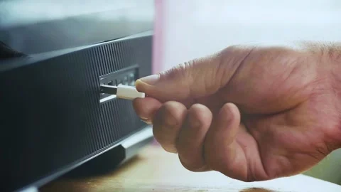 A hand holding a USB stick inserted into the device. Stock Footage 337694259