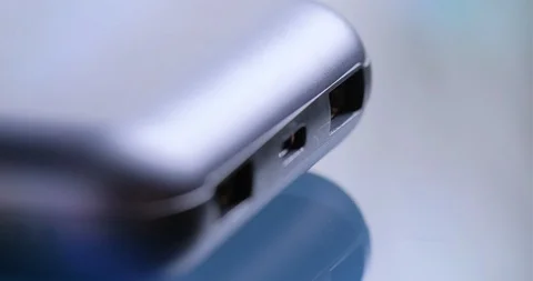 Hand holding USB type C and USB-A cables to connect or disconnect to power bank. Stock Footage 102040530