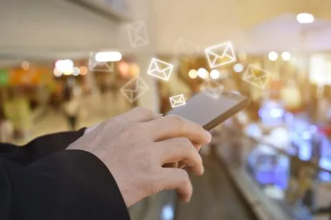 Hand holding using mobile phone with email icon on screen. Concept of busines Stock Photos
