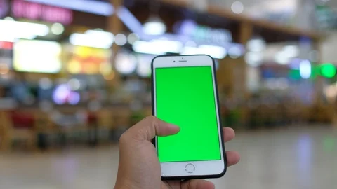 Hand holding using a mobile smartphone green screen Stock Footage 99043135