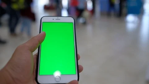 Hand holding using mobile smartphone green screen Stock Footage 99044368