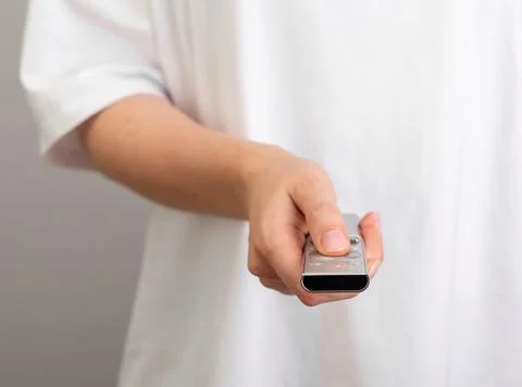 Hand holding, using remote control for TV watching Stock Photos