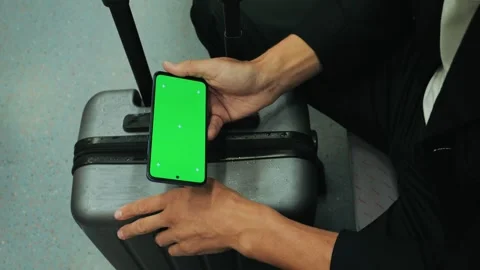 Hand holding using a smartphone with a green screen on the train. Close-up shot Stock Footage 288112198