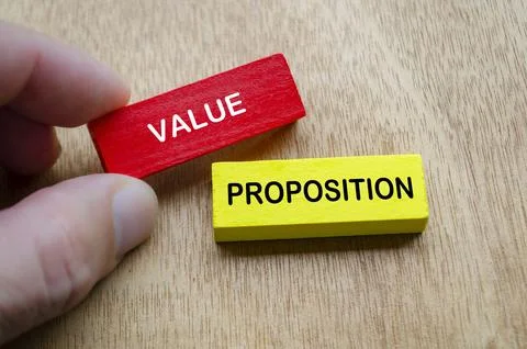 Hand holding Value Proposition text on colored wooden blocks Stock Photos
