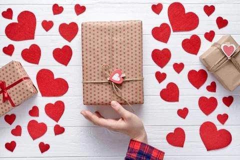 Hand holding vertically and send a gift on Valentine's Day,  birthday. Romanti Stock Photos