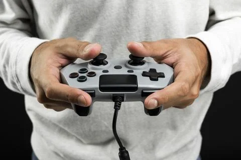 Hand holding video game controller Stock Photos