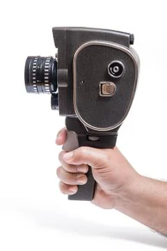 Hand holding a vintage movie camera isolated on white. With clipping path. Stock Photos
