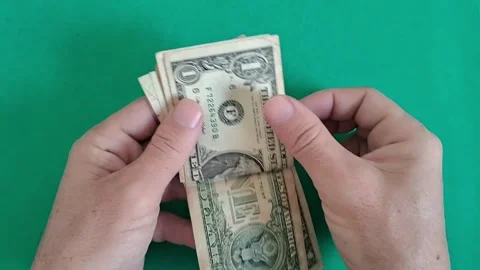 Hand holding vintage US dollar bill close-up. Person examining old paper Stock Footage 340360135