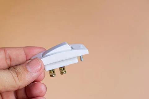 Hand Holding White Electrical Switch Stock Photos