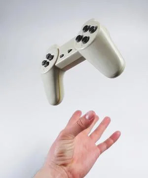 Hand holding a white game controller in the air Stock Photos