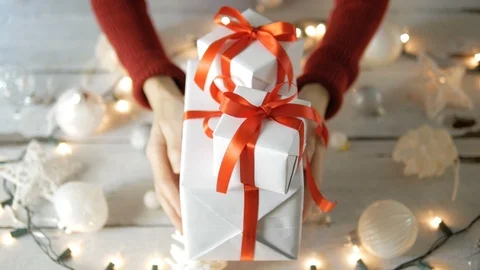 Hand holding white gift boxes with Christmas decoration Stock Footage 95077765