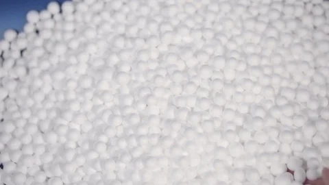 Hand holding white polystyrene foam beads ball Stock Footage 129278253