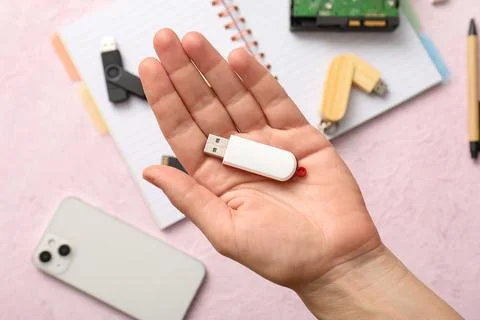 Hand holding white USB flash drive for data storage and digital information t Stock Photos
