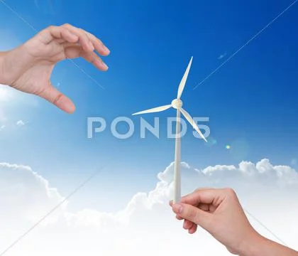 Hand holding wind turbine over blue sky Stock Illustration