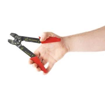 Hand holding a wire stripper tool, composition isolated over the white Stock Photos