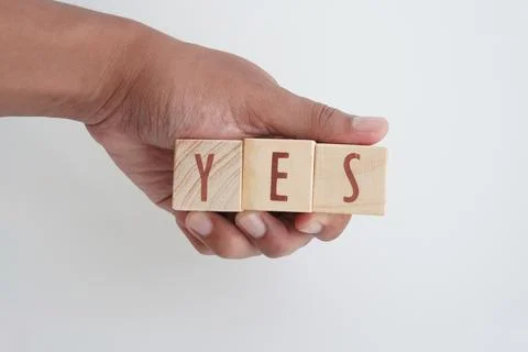 A hand holding the word YES. Stock Photos