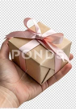 Hand holding wrapped gift box with pink ribbon bow PSD Template
