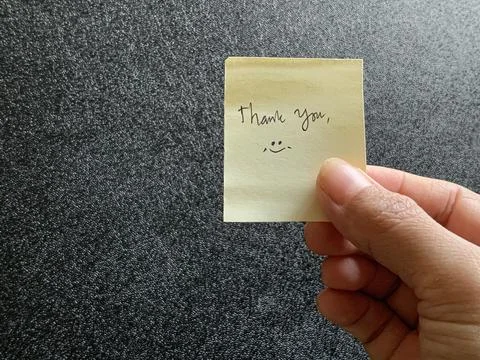 Hand Holding Yellow Paper Note with Handwritten Says Thank You Stock Photos