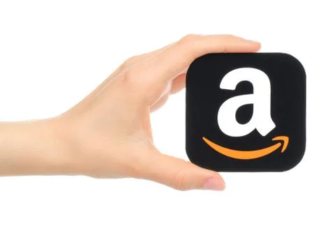 Hand holds Amazon icon printed on paper Stock Illustration