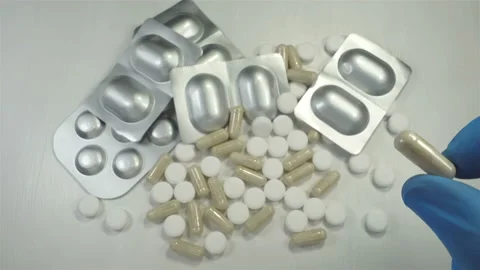 A hand holds and throws a pill in 4K Stock Footage 146679262
