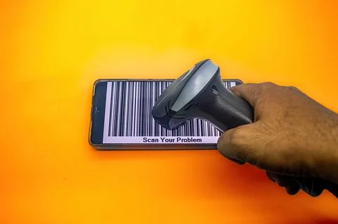 A hand holds a barcode scanner over a smartphone displaying a large barcode.. Stock Photos