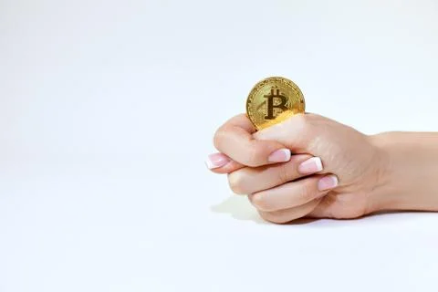 Hand holds bitcoin. Stock Photos