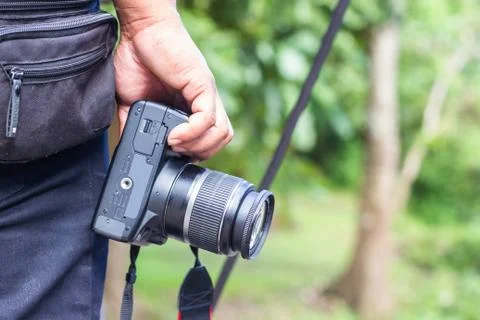 The hand holds the camera on its side with copy space. For book cover, brochu Stock Photos