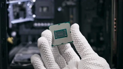The hand holds the central processing unit. The processor is ready to be Stock Footage 147850005