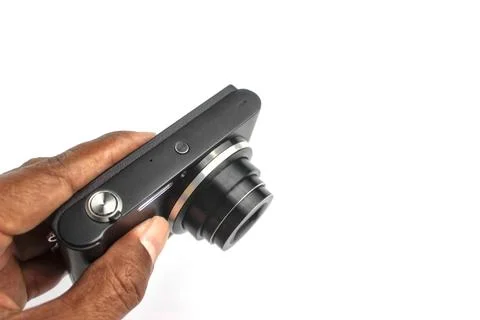 A hand holds a compact camera to take a photo. 库存照片