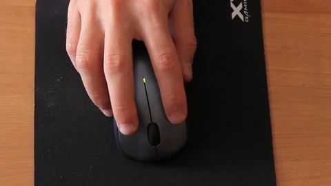 Hand holds computer mouse and uses it Stock Footage 96421992