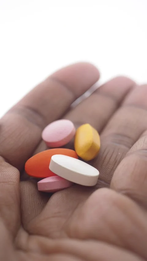 Hand holds different types of medication and vitamins Stock Footage 325442042