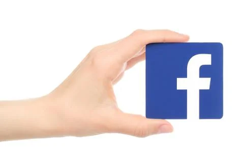 Hand holds facebook logo Stock Photos
