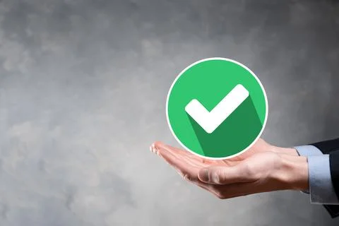Hand holds green icon Check mark,Check Mark Sign, Tick Icon,right sign,circle Stock Photos