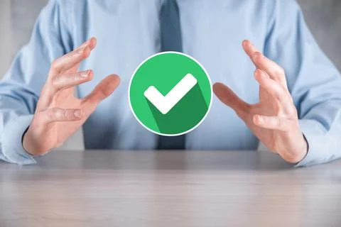 Hand holds green icon Check mark,Check Mark Sign, Tick Icon,right sign,circle Stock Photos