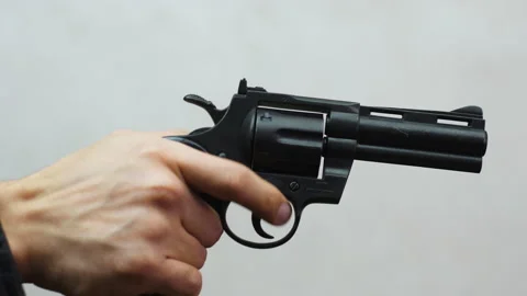 Hand holds a gun 스톡 동영상 168801512