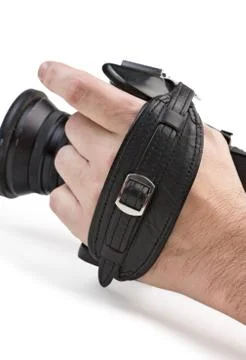 Hand holds the handle of the camera Stock Photos