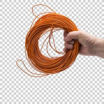 A hand holds a large coil of thin orange wire Fotos de archivo
