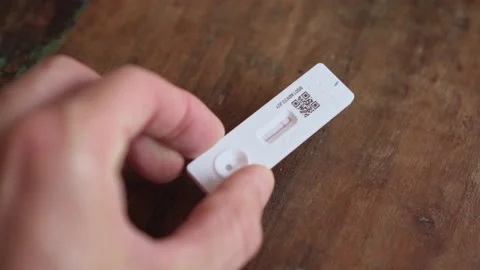 Hand holds up negative Rapid Antigen Test for coronavirus, close up Stock Footage 168669613