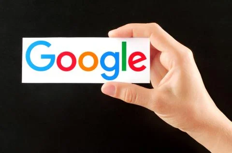 Hand holds new Google logotype Foto stock