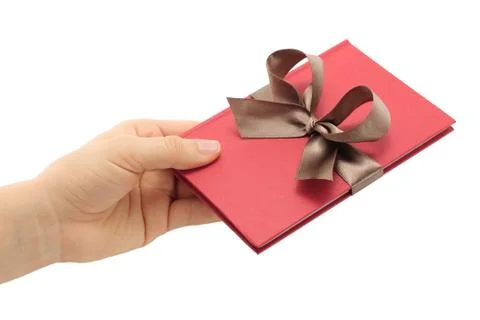 Hand holds notepad with grey bow Stock Photos