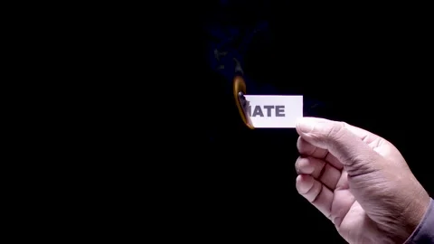 Hand Holds Paper Burning Hate Stock Footage 248536538