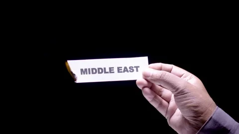 Hand Holds Paper Burning Middle East Video stock 248536849
