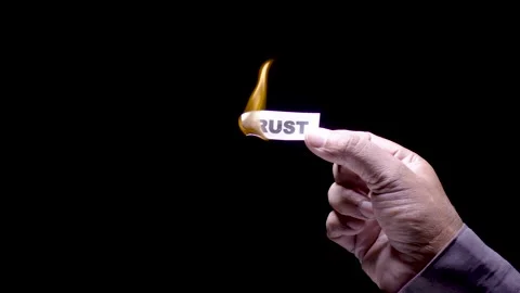 Hand Holds Paper Burning the words Trust Stock Footage 248535067