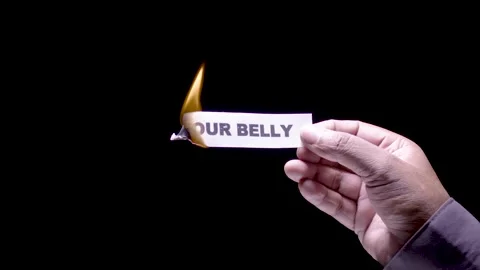 Hand Holds Paper Burning the words Your belly Stock Footage 248535671