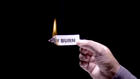 Hand Holds Paper Burning the words Slow burn Stock Footage 248536451