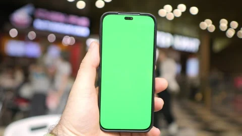 Hand holds phone with green screen Stock Footage 342003586