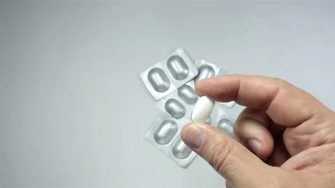 Hand holds pill in 4K Stock Footage 140928744