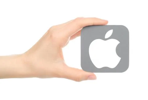 Hand holds popular operating system logo printed on paper Apple ios Illustrazione stock